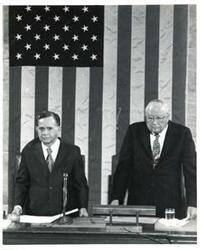 ["Black and white photograph of  Gerald R. Ford speaking at a joint session of Congress. Carl Albert and James O. Eastland also shown. October 8, 1974"]