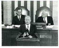 ["Black and white photograph of  Gerald R. Ford speaking at a joint session of Congress. Carl Albert and James O. Eastland also shown. October 8, 1974"]
