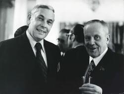 ["Black and white photograph print of close up of two unidentified men."]