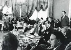 ["Black and white photograph print of Millicent Fenwick, Edward Boland, and others seated at tables, during the House delegation trip. August 1975"]
