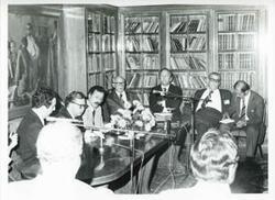 ["Black and white photograph print of Carl Albert, Melvin Price, John Brademas, seated with others around a conference table. House delegation trip. August 1975"]