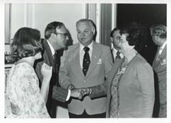 ["Black and white photograph print of a group of unidentified people speaking with one another at the House delegation trip to USSR, Romania, Yugoslavia. August 1975"]