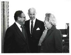 ["Black and white photograph of  Henry Kissinger with two unidentified people."]
