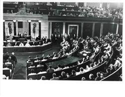 ["Black and white photograph of  A man speaking at a joint session of Congress. Carl Albert shown behind speaker to the right."]