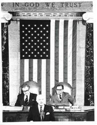 ["Carl Albert, Nelson A. Rockefeller and a guest speaker during a joint session of Congress."]