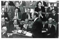 ["Gerald R. Ford's State of the Union message. Carl Albert and Nelson A. Rockefeller are seated behind Ford."]