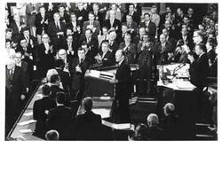 ["Gerald R. Ford's State of the Union message. Carl Albert and Nelson A. Rockefeller are seated behind Ford."]