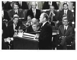 ["Gerald R. Ford's State of the Union message. Carl Albert and Nelson A. Rockefeller are seated behind Ford."]