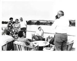 ["Mary Albert shown with a small group of people aboard the Sequoia. July 22, 1975"]