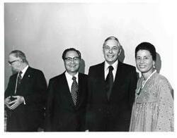 ["Mr. and Mrs. Dong Jo Kim (Korea) shown with a man at their farewell party."]