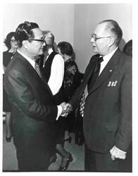 ["Mr. Dong Jo Kim with a man at a farewell party thrown in his honor."]