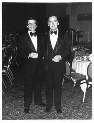 ["Joel Jankowsky (left) in a tuxedo with an unidentified man."]