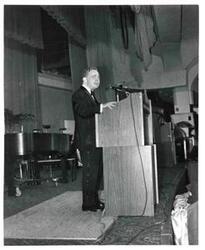 ["Carl Albert standing at a speaker's podium."]