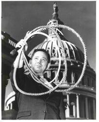 ["Carl Albert holding a whip."]