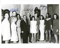 ["From left: Jane Lawton, astronaut Charlie Duke, Polly Ritter, Loise Butler, Carl Albert, astronaut Ken Mattingly, Tamara Kitchens, astronaut John Young, Sue Thompson, Sherry Tonubbee, and Carol Howard."]