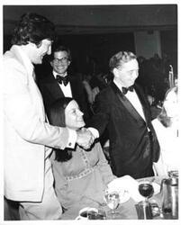 ["Carl Albert shaking hands with another dinner guest. Joel Jankowsky is in the background."]