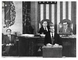 ["Juan Carlos of Spain speaking to the House of Representatives. Carl Albert (left) is seated behind him."]