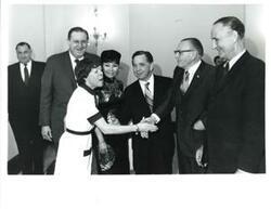 ["Carl Albert and Mary Albert with a small group of people. Mike Mansfield is standing at right."]