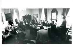 ["Meeting in Carl Albert's office. Presentation of key budget process deadlines. Albert present with his staff members and other congressmen."]
