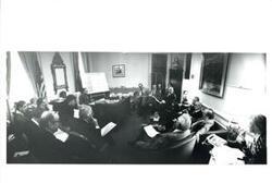 ["Meeting in Carl Albert's office. Presentation of key budget process deadlines. Albert present with his staff members and other congressmen."]