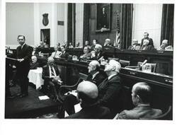 ["Carl Albert at the speaker's podium for the unveiling of Phil Philbin's portrait. Members of Congress are shown."]