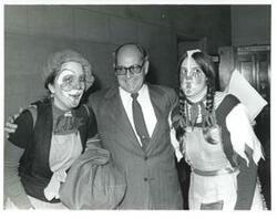 ["Unidentified people, two of whom are dressed as clowns."]