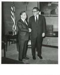 ["Carl Albert shaking hands with Henry Kissinger."]