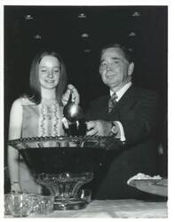 ["Carl Albert pouring punch. Jan Meadows is standing next to him. 1971"]