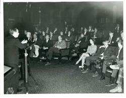 ["Carl Albert at a speaker's podium with a group of high school students. 1970"]