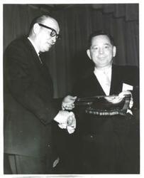 ["Carl Albert receiving a plaque."]