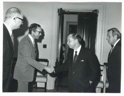 ["Carl Albert shaking hands with a man. John N. Happy Camp at right."]