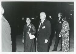 ["Black and white photograph print of Mr. and Mrs. James H. Quillen group of people walking during the House delegation trip to USSR, Romania, and Yugoslavia. August 1975"]