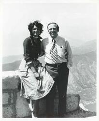 ["Black and white photograph print of John Brademas standing with a woman on top of a mountain."]