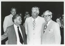 ["Black and white photograph print of Carl Albert posing with George Danielson, Phillip Burton, and others."]