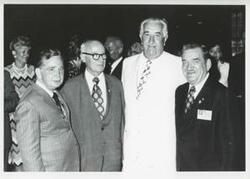 ["Black and white photograph print of Carl Albert posing with Melvin Price, Clement Zablocki, and another man."]