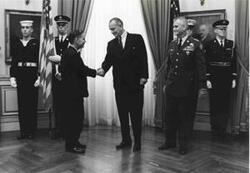 ["Carl Albert shaking hands with Lyndon B. Johnson at the luncheon honoring General William C. Westmoreland. Westmoreland is at Johnson's right. April 1967 Oversized."]