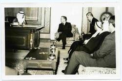 ["Carl Albert at the Kuwait Embassy with Emir Abdul-Rahman Salim Al-Ateeqi, Sheikh Saad Al-Abdullah Al-Salim Al-Sabah, Emir of Kuwait and Commander of the Military of Kuwait  is on the couch and Speaker of Kuwait National Assembly Khalid al-Ghuniam closest to window"]