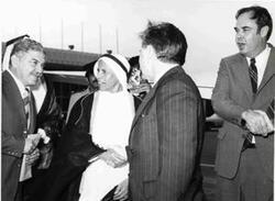 ["Carl Albert with the Interior Ministry of Kuwait at the Embassy in Kuwait : President of Kuwait National Assembly Khalid al-Ghuniam with a plane in the background"]