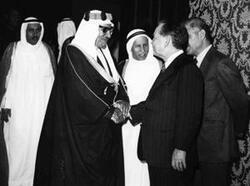 ["Jaber Al-Ahmad Al-Sabah, Prime Minister of Kuwait, shaking hands with Carl Albert, Abdul-Rahman Salim Al-Ateeqi in the back ground left and Khalid al-Ghuniam to the right of Albert"]