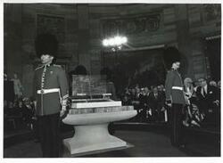 ["Black and white photograph print of several people at a ceremony in the Capitol rotunda honoring arrival of the Magna Carta."]