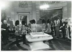 ["Black and white photograph print of several people at a ceremony in the Capitol rotunda honoring arrival of the Magna Carta."]