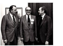 ["The image depicts Dewey Bartlett standing with Henry Bellmon and Homer Peay"]