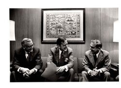 ["The image depicts Dewey Bartlett seated with A. G. Foster and D.E. Procksow"]