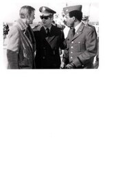 ["The image depicts Dewey Bartlett standing with Colonel Anthony A. Smith and Captain W. A. Soders"]