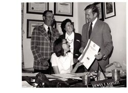 ["The image depicts Dewey Bartlett presenting Paula Merritt an Okie certificate"]