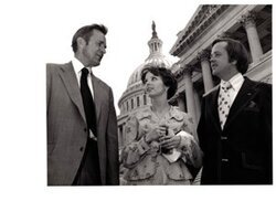 ["The image depicts Dewey Bartlett standing with Jill and Marty Adams in front of the capitol"]