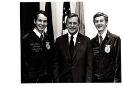 ["The image depicts Dewey Bartlett standing with Robin Osborn and Deo Saralosky, FFA Officers"]