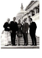 ["The image depicts Dewey Bartlett standing with Mary Weldon, Steph Irwin, Johnnie Cherblanc, and Tom Cantrell in front of the Capitol"]