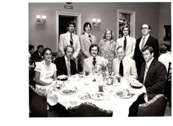 ["The image depicts Dewey Bartlett seated at a dinner table with (standing L to R) Don Vaught, Ben Kirk, Ethie Weaver, Jeff Pierson, and (seated L to R) with Jane Wheeler, and Ed Kimmel. All are second session interns"]