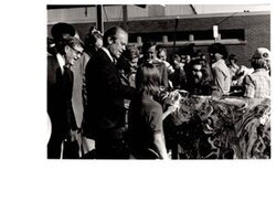 ["The image depicts Dewey Bartlett standing with Ann Bartlett, Gerald Ford, and several other people"]